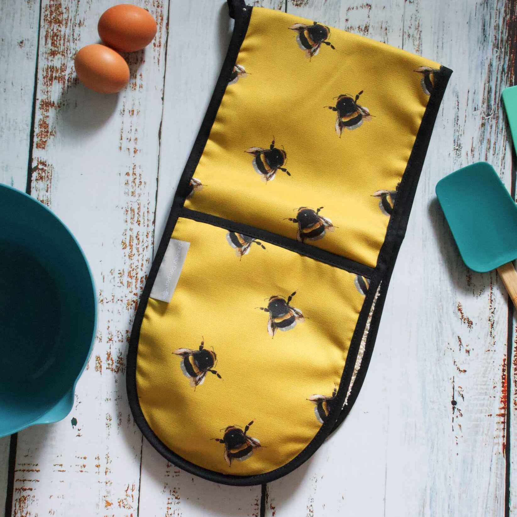 Yellow oven gloves with bee pattern