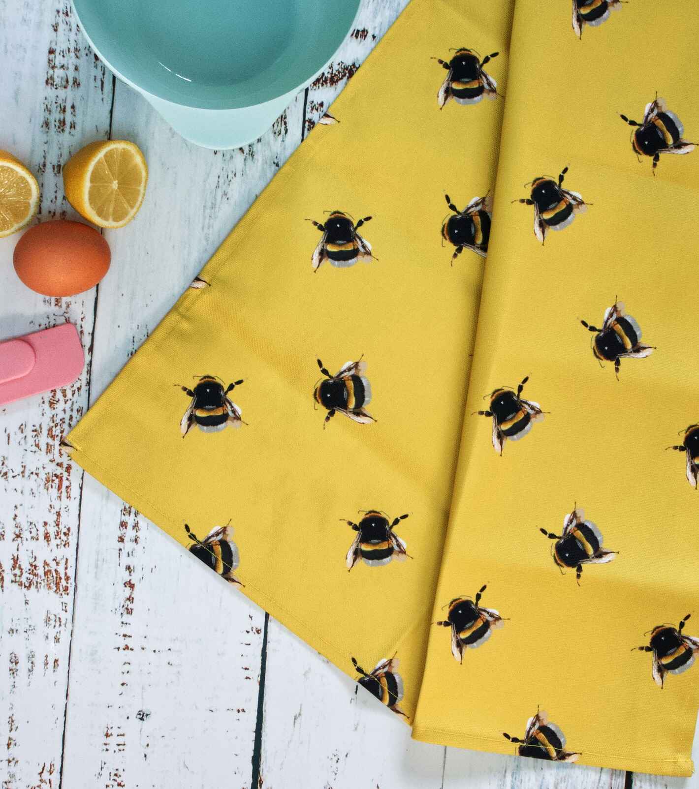 yellow tea towel with bee pattern